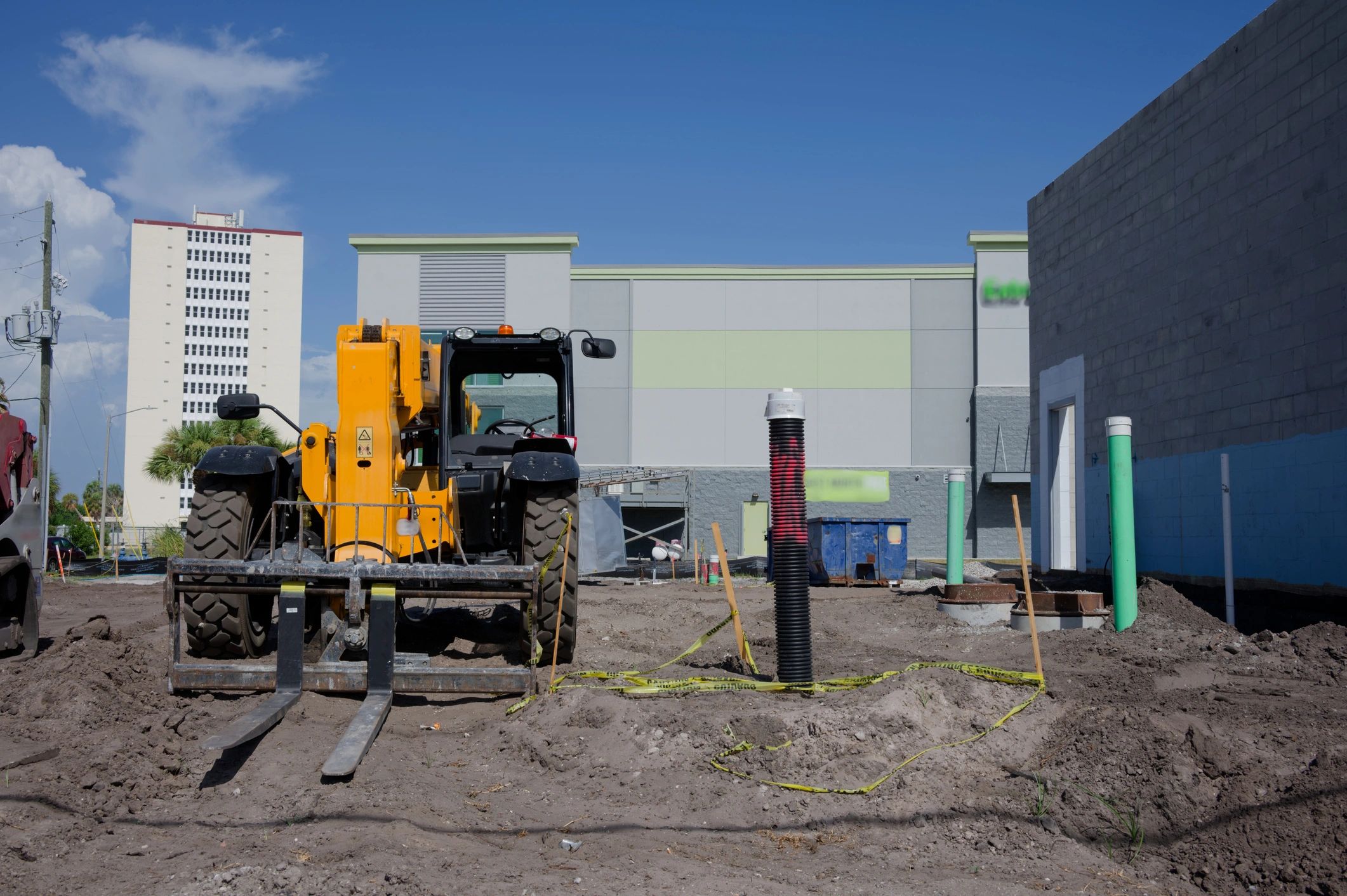 Commercial construction site with utility work underway